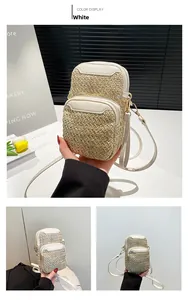 Detail view of woven straw mobile phone bag with white leather trim and gold zippers