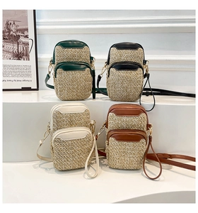 Close-up of four-color woven mini crossbody bags with dual zippers and leather trim details