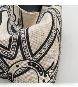 Detailed macro view of durable cream canvas fabric with black equestrian motifs