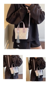 Detail of lavender jacquard bucket bag with silk tassel and adjustable leather strap