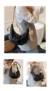 Three-way view of a black crocodile pattern crescent bag with a cute bear charm