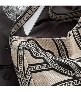 Close-up of high-quality stitching and geometric jacquard fabric on a canvas tote bag