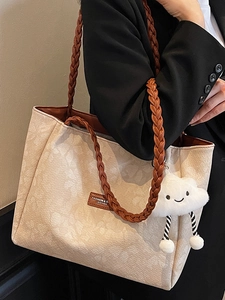 Women's cream floral embossed tote bag with brown woven handles and cloud charm accessory