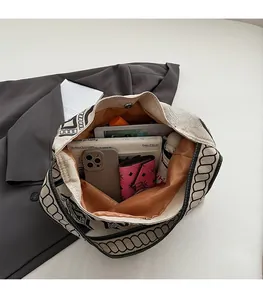 Spacious interior of beige canvas tote bag showing large capacity for daily essentials