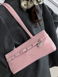 Pink glossy faux leather underarm bag with silver heart charm and metal eyelet details