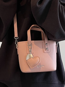 Pink faux leather bucket bag with heart charm and crossbody strap for women