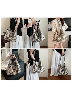 Large beige canvas tote bag with black geometric print shown in various poses