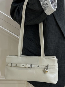 Minimalist beige shoulder bag with buckle strap and silver heart pendant for women