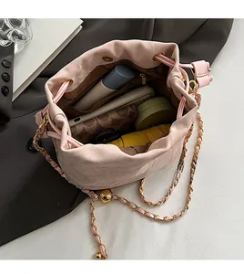 Macro view of pink drawstring bucket bag showing its spacious interior for daily essentials