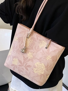 Pink floral bucket bag with silver charm and slim shoulder strap for women
