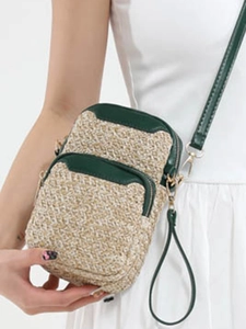 Woven straw mini crossbody bag with green leather trim and dual zipper detail