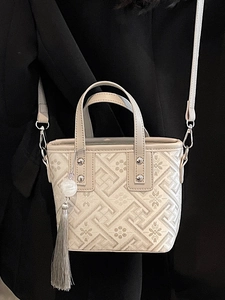 Elegant Chinese style beige jacquard bucket bag with floral embroidery and silver tassel detail