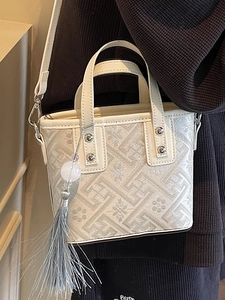 Elegant cream Chinese style bucket bag with geometric jacquard embroidery and tassel charm