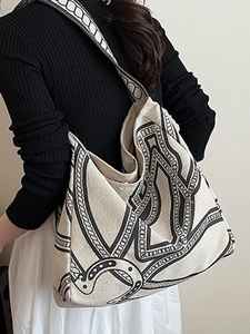 Minimalist large canvas tote bag with abstract print shown on model for daily commute