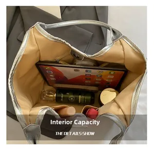 Macro view of silver tote bag interior showing spacious capacity and magnetic closure