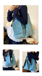 Macro detail of the vintage blue faux leather tote bag with distressed texture and mini pouch