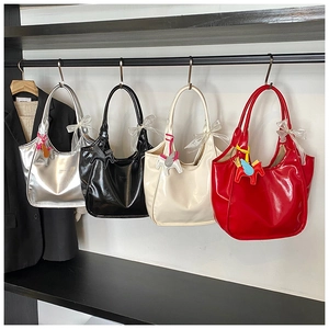 Detail view of four glossy leather tote bags in silver black white and pink with cute charms