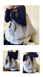 Detail view of large gray distressed tote bag shown with model for size and capacity