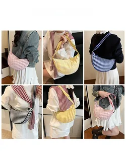 Detail view of stylish checkered crescent bags in multiple colors with adjustable straps