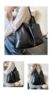Detail view of large black glossy tote bag with matching small pouch for commuting