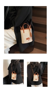 Detail of woven straw bucket bag showing brown leather stitching and tassel tassel knot