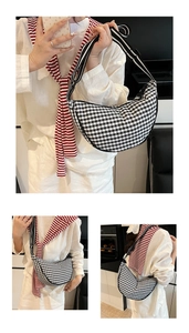 Detail of black and white gingham crescent bag with striped shoulder strap for women