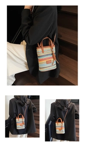Detailed macro view of colorful striped woven texture and premium leather handle of the bag