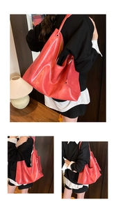 Macro detail of red matte leather tote bag with side zipper and vintage texture design