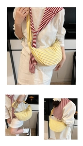 Detail view of yellow plaid crescent bag featuring durable fabric and wide strap