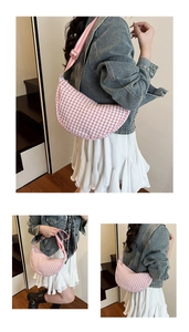 Detail of pink plaid crescent bag with adjustable strap and smooth zipper closure