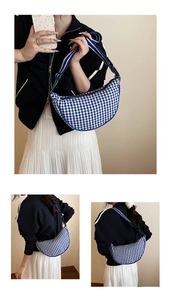 Detail of blue and white checkered crescent shoulder bag with adjustable strap