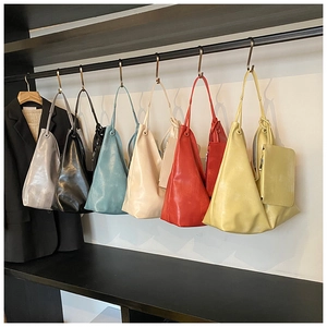 Detailed display of colorful leather tote bags showing various color options and texture