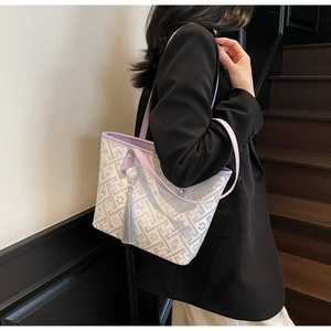 Dettaglio della borsa tote con motivo di orchidee viola e nappine in seta decorative