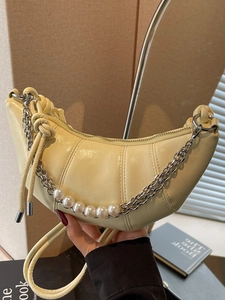 Light yellow crescent moon bag with pleated texture and pearl chain handle details