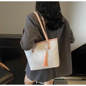 Vista posteriore di una borsa tote in jacquard bianco con manici in pelle rosa e nappa