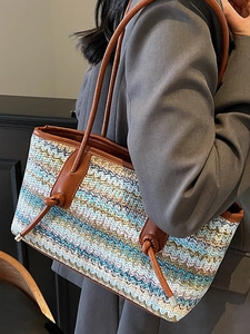 Bohemian woven straw tote bag with colorful wave patterns and brown leather handles
