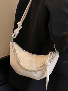 Chic beige croissant crescent bag with glossy finish and pearl chain detail for women