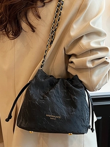 Chic black drawstring bucket bag with gold chain strap and crinkled texture fabric