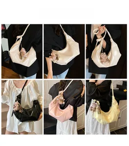 Collage of glossy half-moon bags in white, black, pink, and yellow with teddy bear charms
