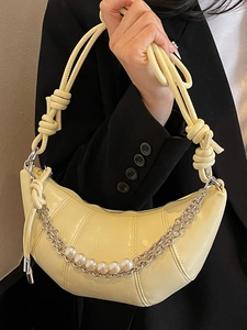 Chic cream yellow crescent handbag with knotted handle and pearl chain decoration