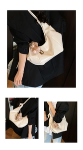 Detail of cream glossy leather crescent bag with shoulder strap and plush bear charm