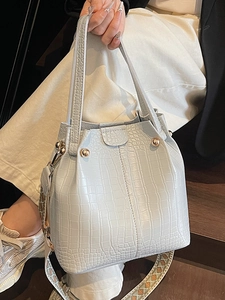 Blue crocodile pattern bucket bag with ethnic woven wide strap and golden rivets
