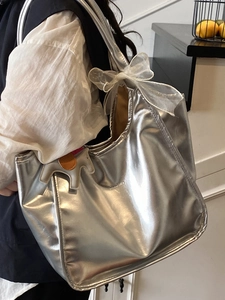 Metallic silver tote bag with white organza bow and horse charm for 2025 summer fashion