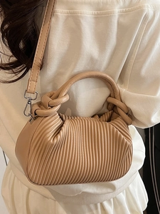 Elegant beige pleated handbag with cylindrical handle and detachable shoulder strap in a soft style