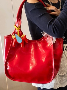 Chic red oil wax leather tote bag with horse charm, ideal for student commute and work