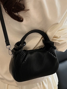 Minimalist black pleated handbag with silver hardware and adjustable shoulder strap