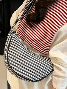 Chic black and white checkered crescent crossbody bag with adjustable strap for women