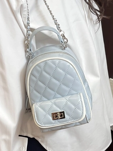 Fashionable light blue quilted mini backpack with chain straps and metallic twist lock