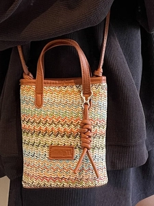 Colorful striped woven mini tote bag with leather handles and adjustable shoulder strap