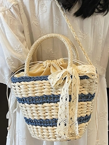 French style woven straw bucket bag with blue stripes and elegant lace drawstring detail